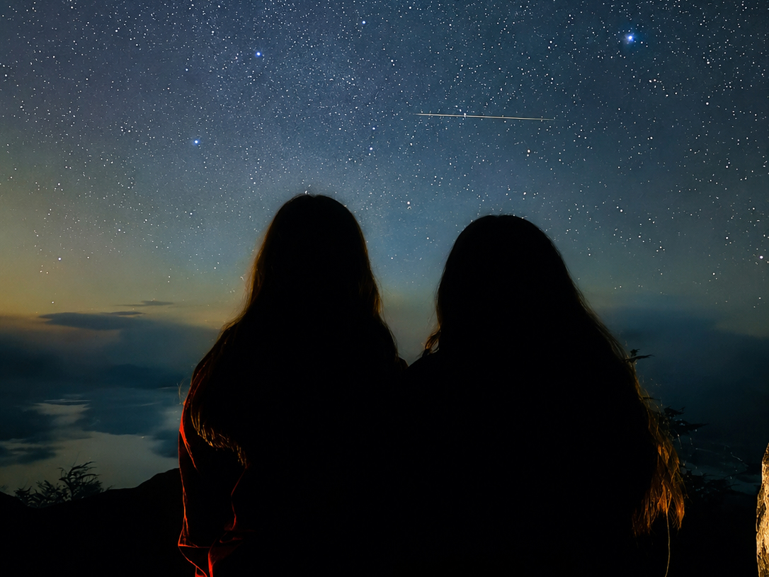 Two travelers watching the Milky Way in the Andes